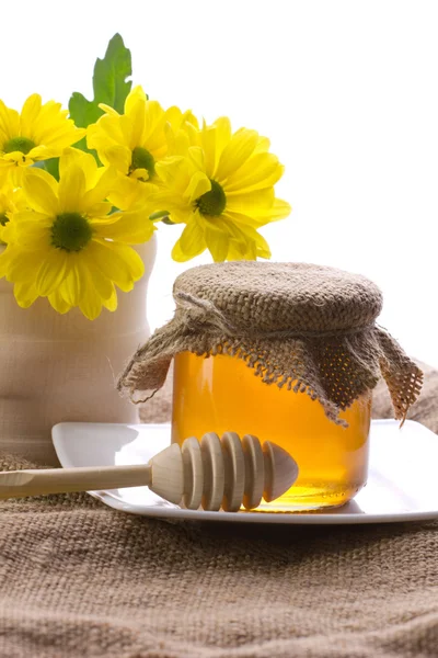 Closeup of honey and flowers — Stock Photo, Image
