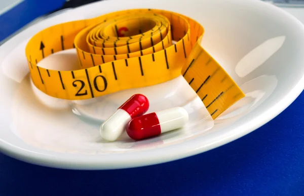 Measure and pills for dieting concept — Stock Photo, Image