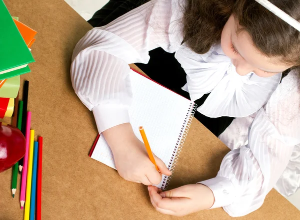 Little schoolgirl writing — Stock Photo, Image