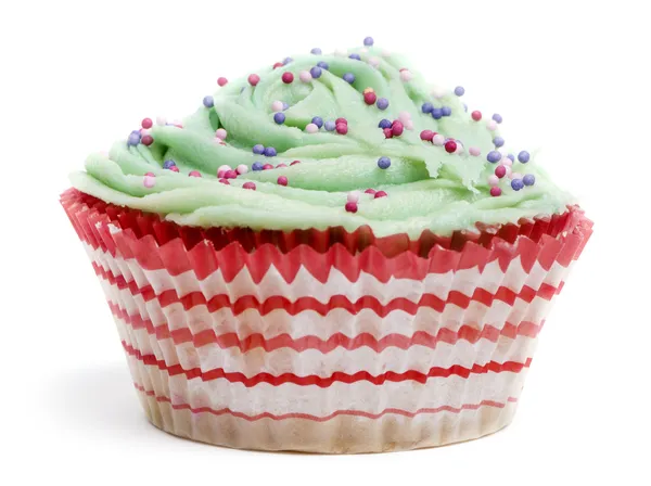 Cupcake with green icing and hundreds and thousands against white background in front of white background — Stock Photo, Image