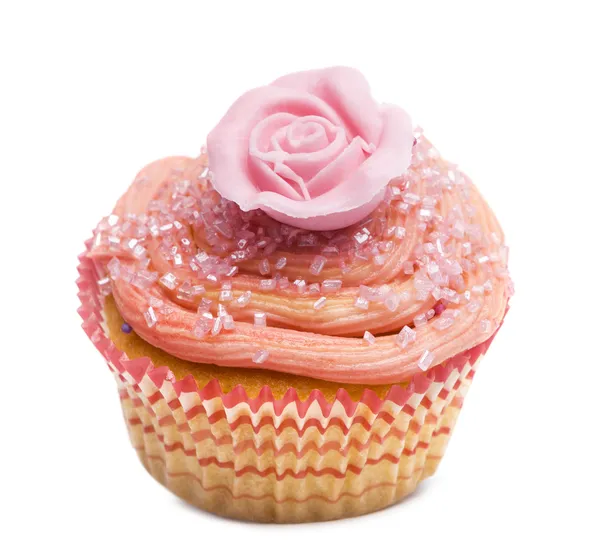 Cupcake with pink flower decoration against white background in front of white background — Stock Photo, Image