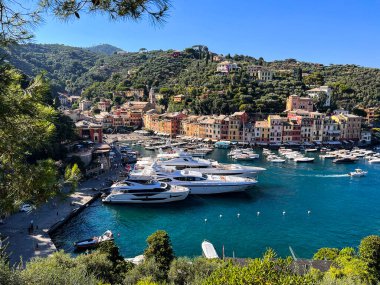 Portofino, Italy - July 8th, 2022: The beautiful Portofino with visual pollution large yachts in front of
