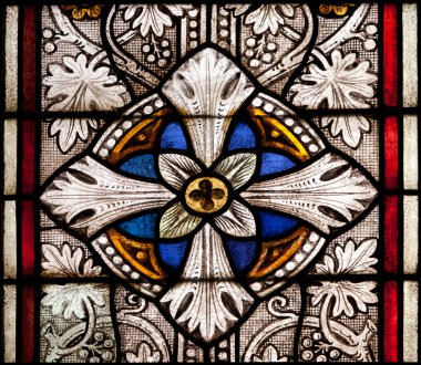 Fragment of colored ornamental glass of window of the church clipart
