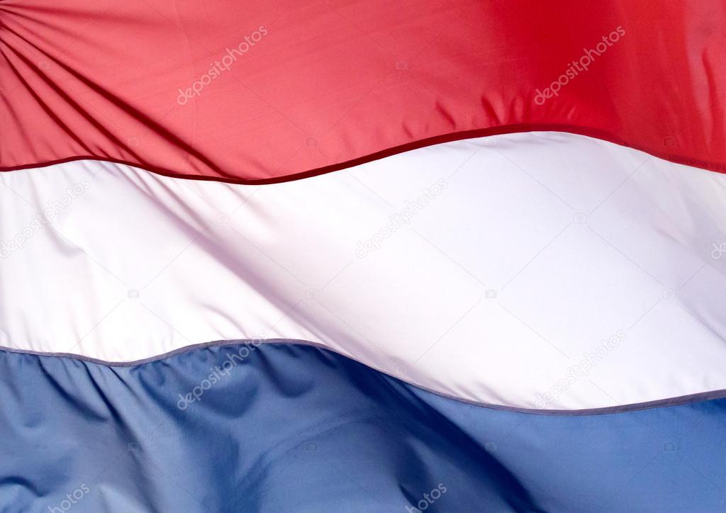 Fragment of Netherlands flag against the blue sky