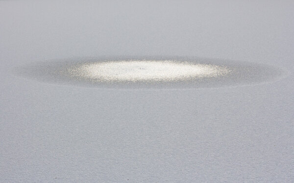 Frozen ice hole on the river