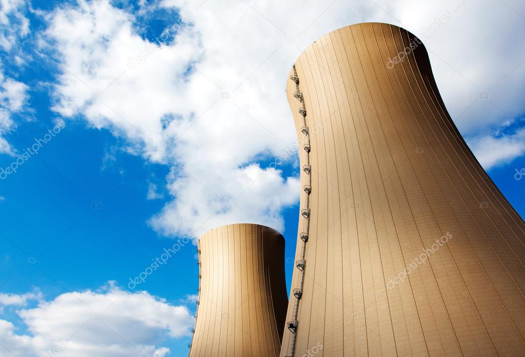 Nuclear power plant against blue sky and clouds