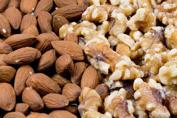 Close up of shelled walnuts and almonds — Stock Photo, Image