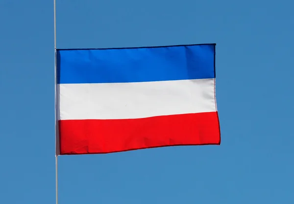 Dutch flag in wind against the blue sky — Zdjęcie stockowe