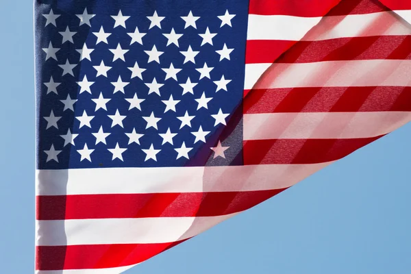 The American flag in wind against a sky Stock Image