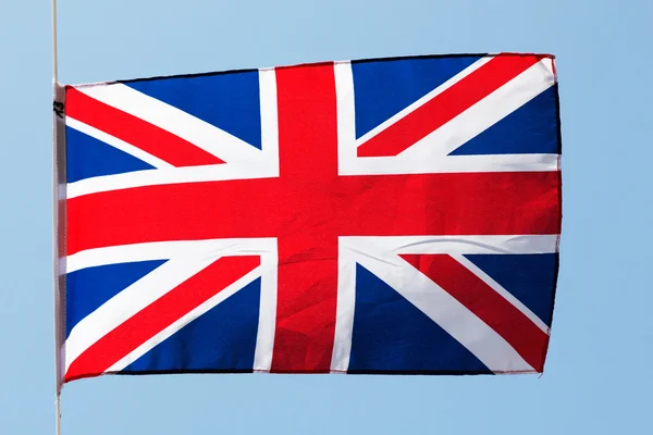 English flag in the wind against a blue sky — Stock Photo, Image