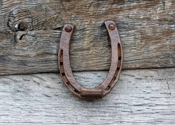 Old horseshoe on wooden background — Stock Photo, Image