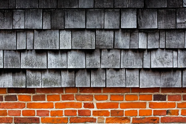 Wooden tiles on a brick wall — Stock Photo, Image