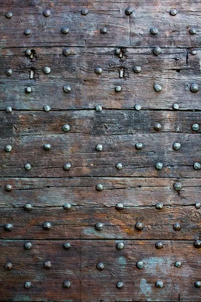 Old, brown wooden surface with metal knobs — Stock Photo, Image