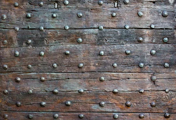 The old wooden surface with metal knobs — Stock Photo, Image