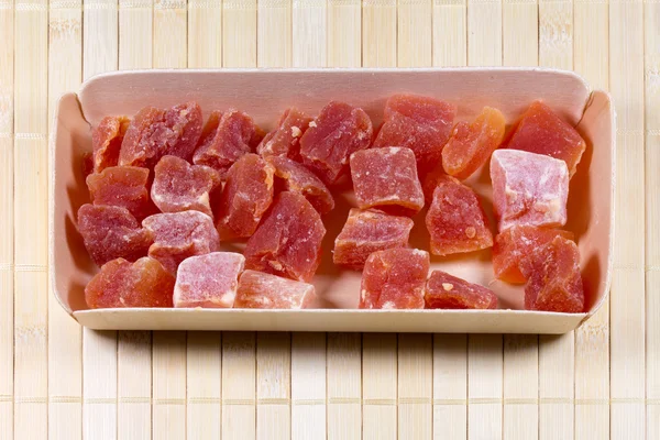 Candied fruits in wooden box on straw mat — Stock Photo, Image