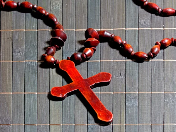 Wooden cross on bamboo mat — Stock Photo, Image