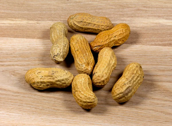 Peanut closeup on the wooden surface — Stock Photo, Image