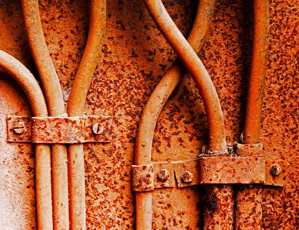 Old electrical cables on rusty iron wall — Stock Photo, Image