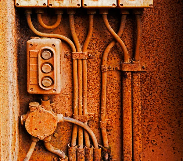 Old electric switch on a rusty iron wall — Stock Photo, Image