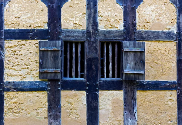 Wooden shutters in the wall of old adobe house — Stock Photo, Image