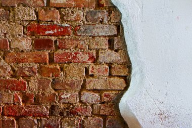 Old plaster on a red brick wall
