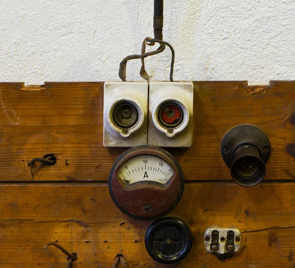 Measuring device socket and fuse on wooden panel — Stock Photo, Image