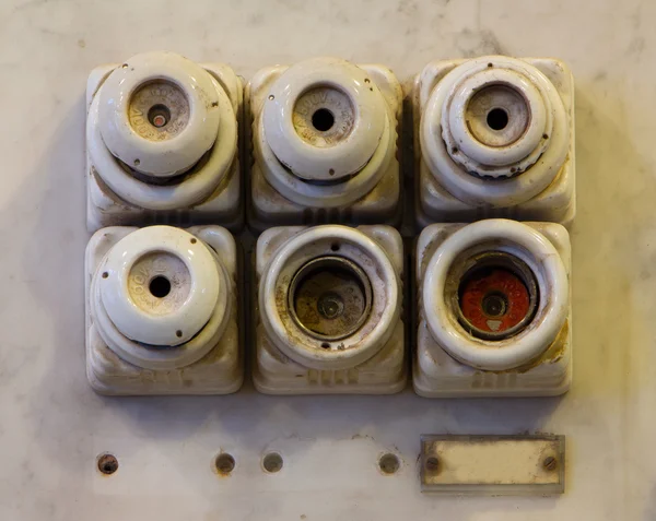 The old ceramic fuses on a wall — Stock Photo, Image