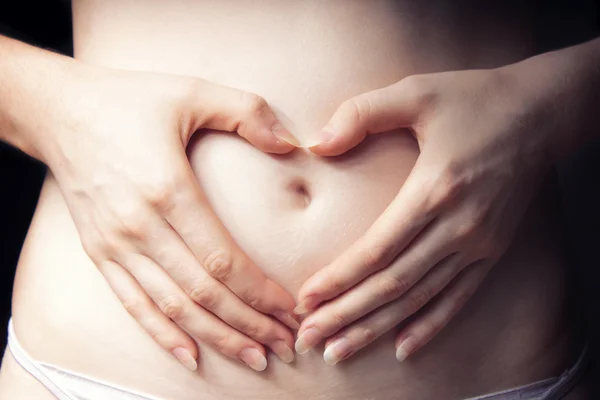 Shape of heart on belly — Stock Photo, Image