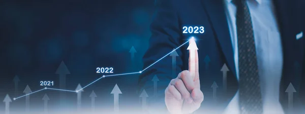 Businessman using finger touch symbol stock graph and chart background,concept growth and development business investment,Stock market and strategy making market plan and stock market fluctuations