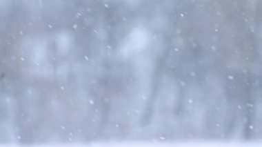 Kar taneleri kışın yavaş çekimde Bokeh 'ten düşer. Kar yağışlı büyüleyici bir video..