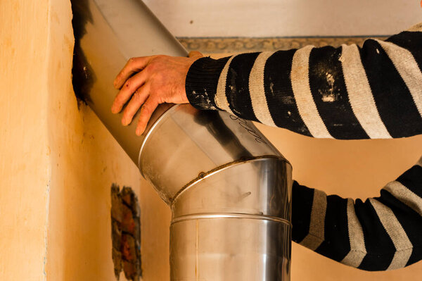 Chimney for the fireplace, installation of a pipe over the fireplace to the chimney, repair work in the house. new