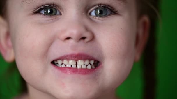 The girl shows her baby teeth, white baby teeth, oral hygiene, slow movement of the child. — Stock Video