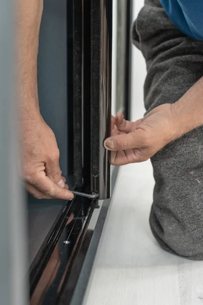 Assembly of mirrored doors to a sliding wardrobe, installation of a case by means of the hexagonal screw, work with the detailed plan.