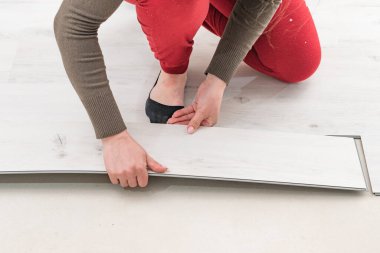 Zemin kurulumu, yeni bir kuvars stili vinil zemin döşeme onarımı, döşeme onarımı, bir kadın döşeme montajı.