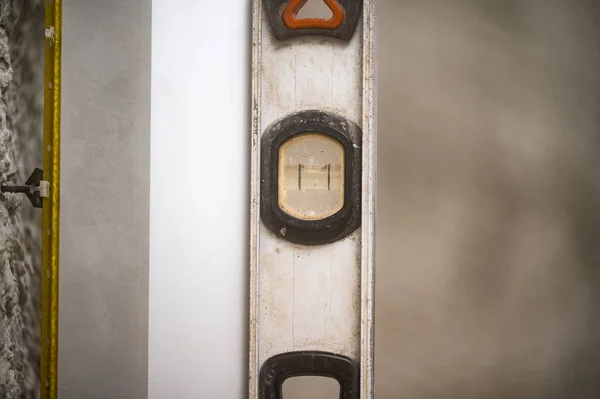 metal guide beacons are attached to the wall, the master checks the beacons for equality of the plane rule, building rule with level and metal beacon.