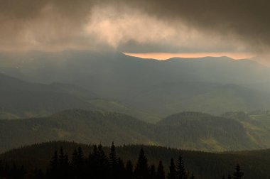 Rain clouds in the Carpathians, overcast Mount Petros, rain clouds and sun rays.