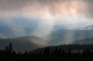 Rain clouds in the Carpathians, overcast Mount Petros, rain clouds and sun rays.