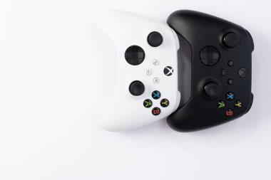 Ivano-Frankivsk, Ukraine August 14, 2022: x series gamepad on a white background, black and white gamepads for games.