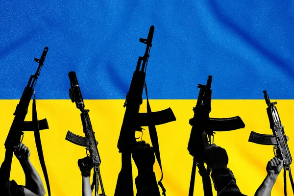 The flag of Ukraine and combat military assault rifles AK 74 and AK 74U on its background, war and destruction, the country was attacked.
