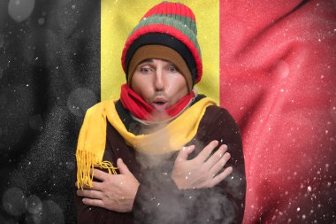Belgium suffers the consequences of a cold and unheated winter, a European freezes from the cold and warms himself with steam from his mouth.