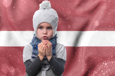 Gas crisis in Latvia, Cold winter and high gas tariffs, a little girl is frozen, a child without heat in winter blows his hands to keep warm.