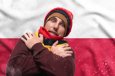 Gas crisis in Poland, Cold winter and high gas tariffs, a European surprised by gas prices, a man warms himself with a hat and scarves.