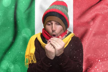 Cold winter and consequences of gas sanctions, consequences of the war in Ukraine, shortage of gas and heat in Italy, a man who is frozen warms himself with his warmth, Europeans have no warmth.