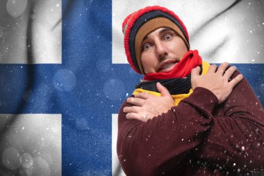 Gas crisis in Finland, Cold winter and high gas prices, a European surprised by gas prices, a man warms himself with a hat and scarves.