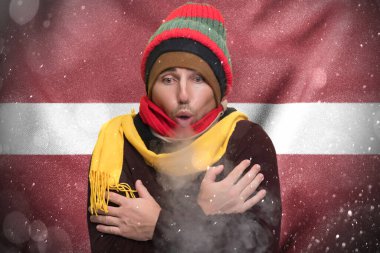 Gas crisis in Latvia, Cold winter and high gas tariffs, a European freezes from the cold and warms himself with steam from his mouth.