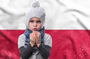 Gas crisis in Poland, Cold winter and high gas tariffs, a little girl is frozen, a child without heat in winter blows his hands to keep warm.