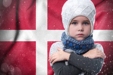 Gas crisis in Denmark, Cold winter and high gas tariffs, the girl is frozen, the child without heat in winter hugs himself with his arms to keep warm.