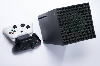 Ivano-Frankivsk, Ukraine August 14, 2022: gamepad and console on a white background, black and white gamepads, game console from Microsoft.