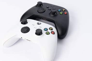 Ivano-Frankivsk, Ukraine August 14, 2022: x series gamepad on a white background, black and white gamepads for games.
