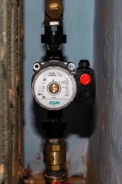Dolyna, Ukraine March 24, 2021: installation of a wilo water pump in the heating system, home heating.